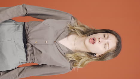 Vertical-video-of-Sleepy-young-woman-yawns.
